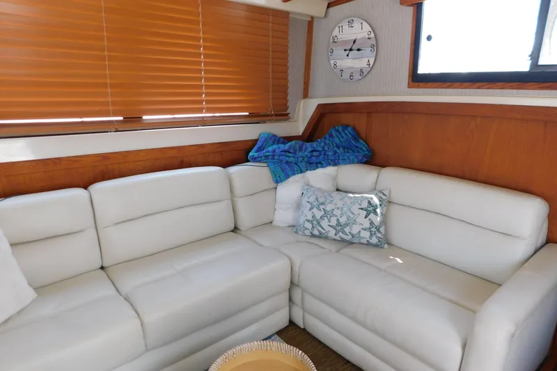 Slide: The Image of Interior of 1987 Mainship 40 DC yacht with white leather sofa and nautical decor. - 23