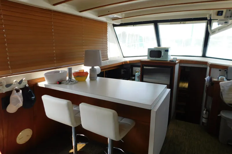 Slide: The Image of Interior of 1987 Mainship 40 DC yacht with modern kitchen and seating area. - 24
