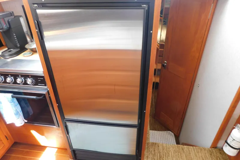 Slide: The Image of 1987 Mainship 40 DC yacht kitchen with stainless steel fridge and stove. - 27