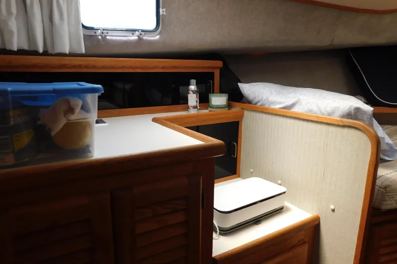 Slide: The Image of Interior of 1987 Mainship 40 DC boat with wooden cabinetry and cozy sleeping area. - 29