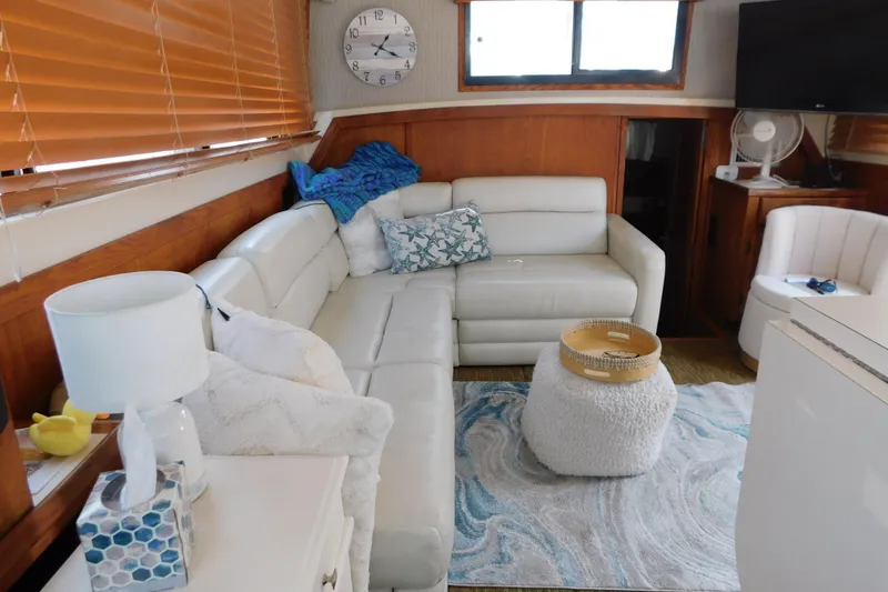 Slide: The Image of Cozy interior of 1987 Mainship 40 DC yacht with white leather seating and nautical decor. - 34