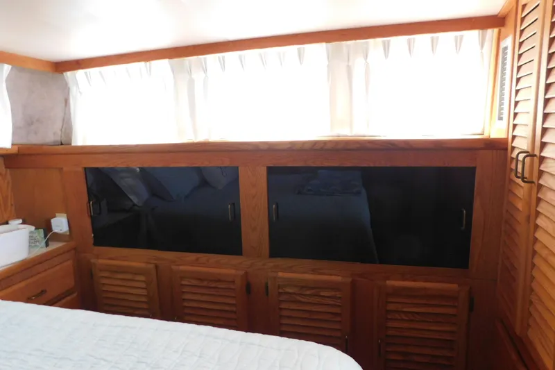 Slide: The Image of Interior of 1987 Mainship 40 DC yacht with wooden cabinetry and curtained windows. - 37
