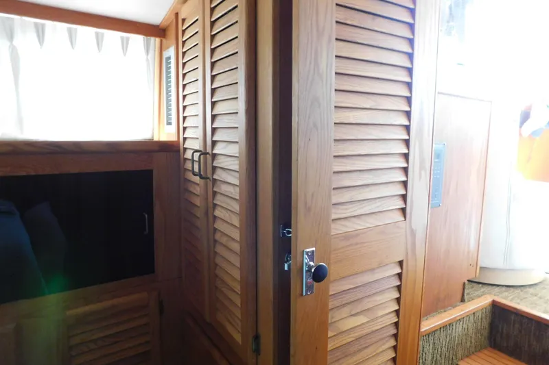 Slide: The Image of Interior of 1987 Mainship 40 DC with wooden cabinetry and louvered doors. - 38