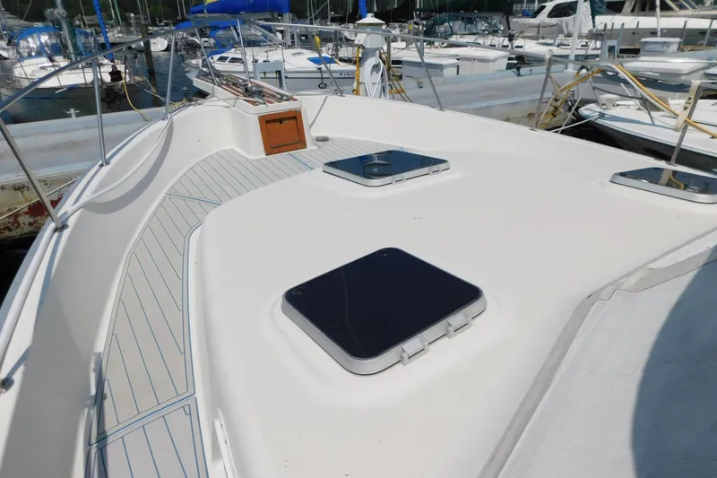 Slide: The Image of 1987 Mainship 40 DC yacht deck with hatches, docked in a marina. - 39