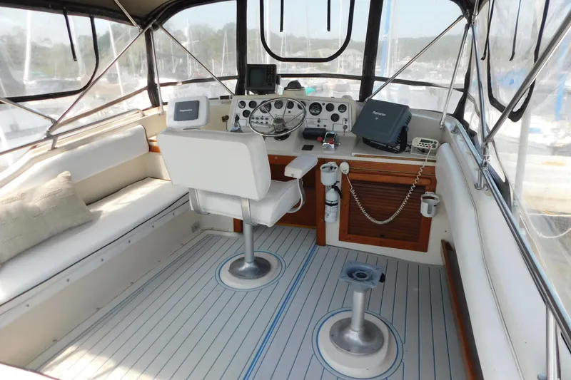 Slide: The Image of 1987 Mainship 40 DC yacht cockpit with helm, seating, and navigation equipment. - 4