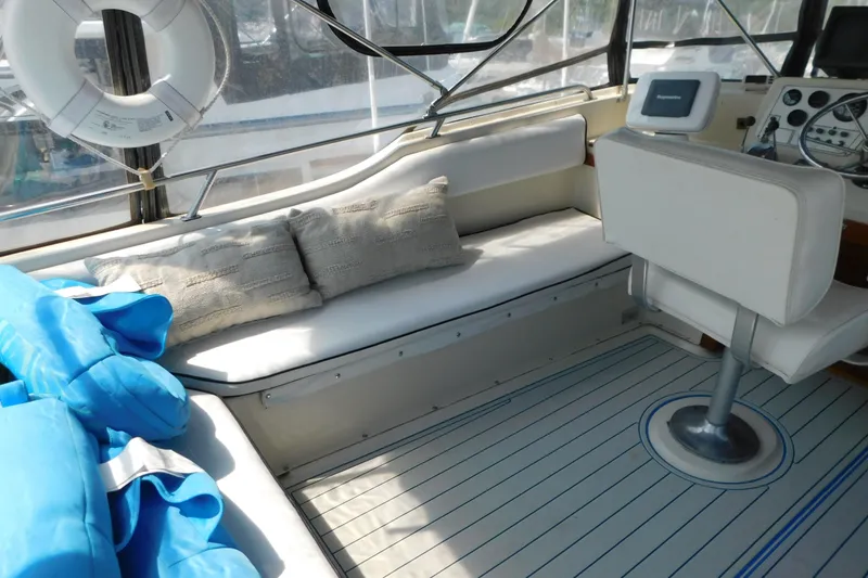 Slide: The Image of 1987 Mainship 40 DC boat interior with seating, life preserver, and navigation equipment. - 5