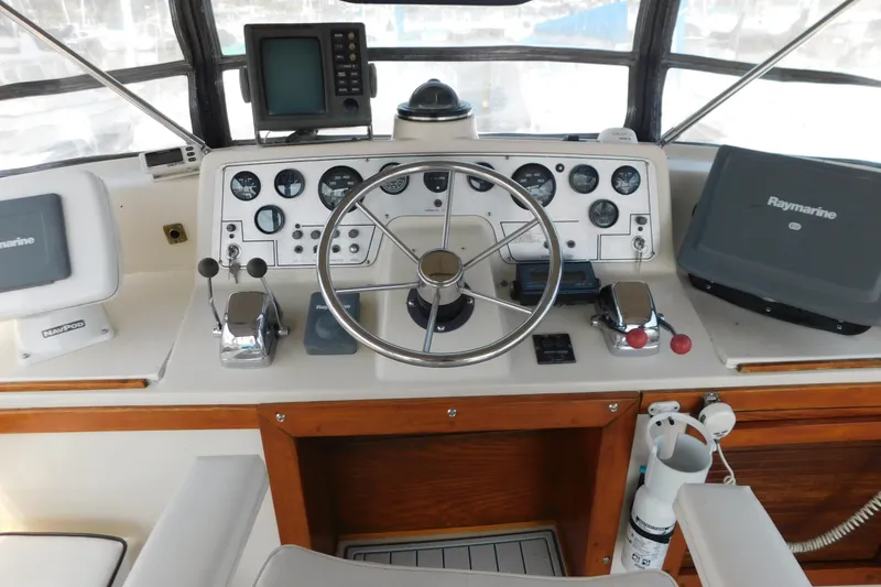 Slide: The Image of 1987 Mainship 40 DC helm with steering wheel, gauges, and navigation equipment. - 7