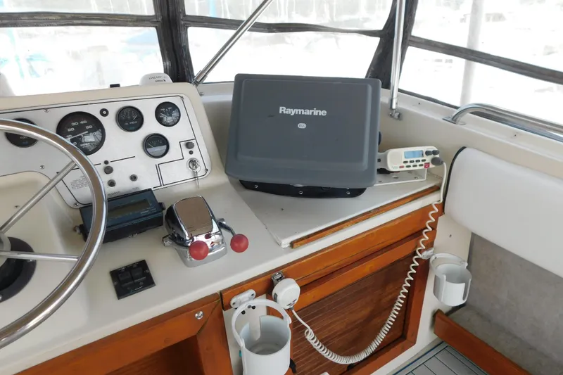 Slide: The Image of 1987 Mainship 40 DC helm with Raymarine equipment and classic controls. - 8