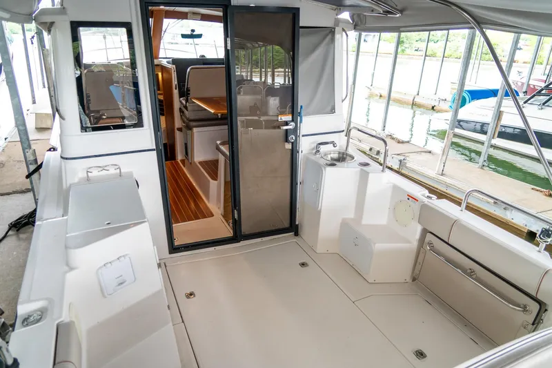 Slide: The Image of 2020 Cutwater C28 boat interior with open cabin door, docked at marina. - 10