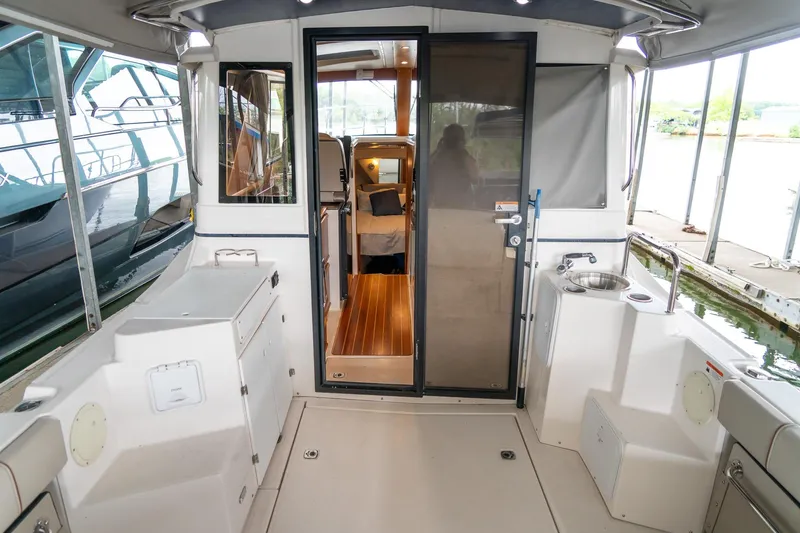Slide: The Image of 2020 Cutwater C28 boat interior with open cabin door, showcasing sleek design and amenities. - 11