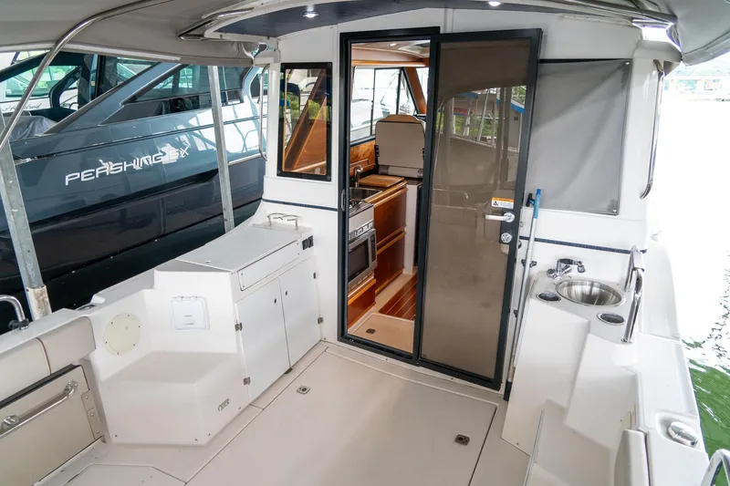 Slide: The Image of 2020 Cutwater C28 boat interior with kitchenette and seating area. - 12