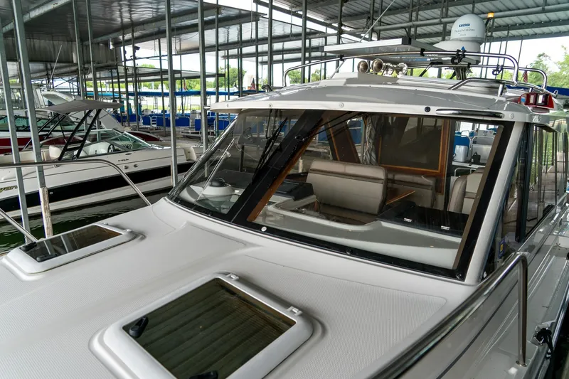 Slide: The Image of 2020 Cutwater C28 boat docked in a covered marina, showcasing sleek design. - 16