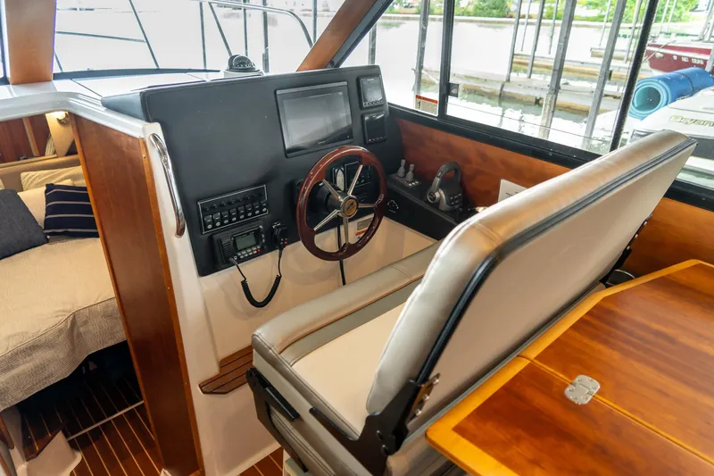 Slide: The Image of Interior helm of 2020 Cutwater C28 boat with steering wheel and navigation controls. - 26