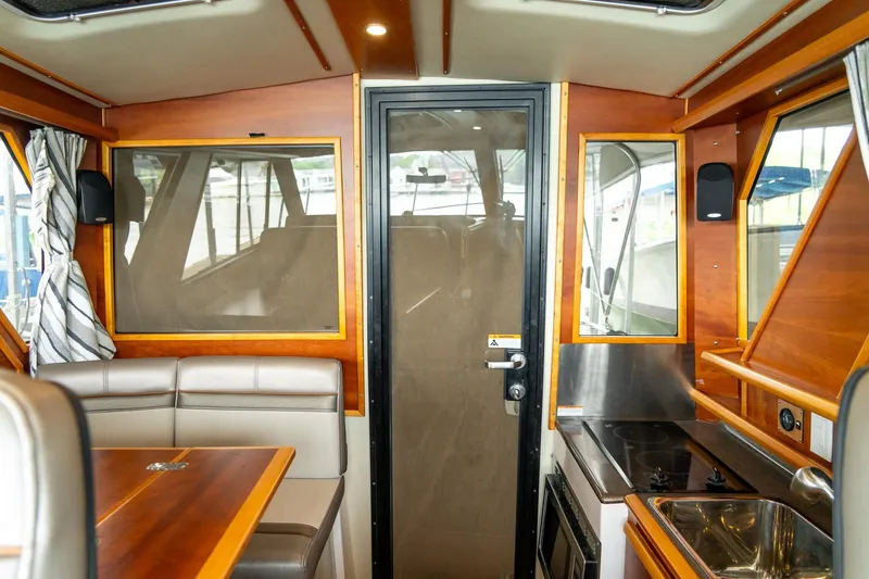 Slide: The Image of Interior of 2020 Cutwater C28 boat featuring kitchen and seating area. - 30