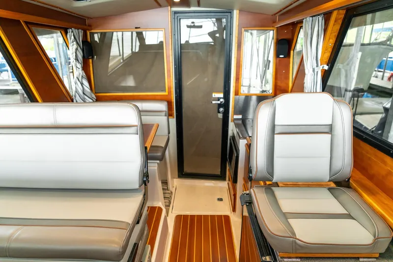Slide: The Image of Interior of 2020 Cutwater C28 boat with modern seating and wood accents. - 31