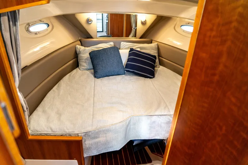 Slide: The Image of 2020 Cutwater C28 cabin interior with cozy bed and decorative pillows. - 35