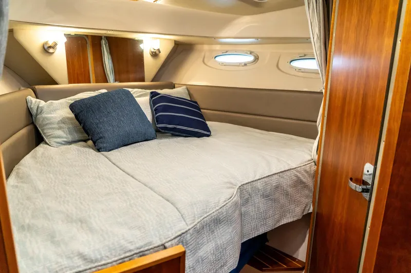 Slide: The Image of Cozy cabin interior of 2020 Cutwater C28 boat with comfortable bedding and pillows. - 36