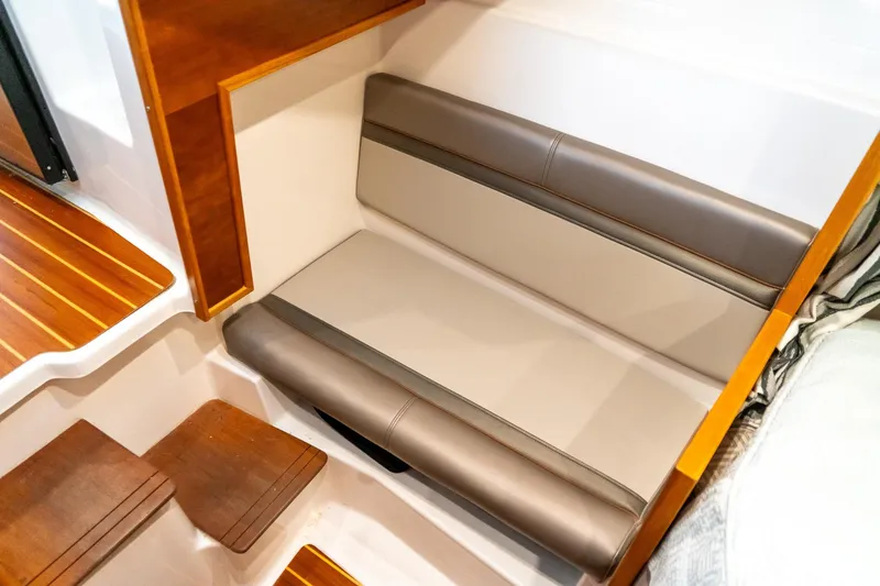 Slide: The Image of 2020 Cutwater C28 interior seating with wooden accents and modern design. - 38