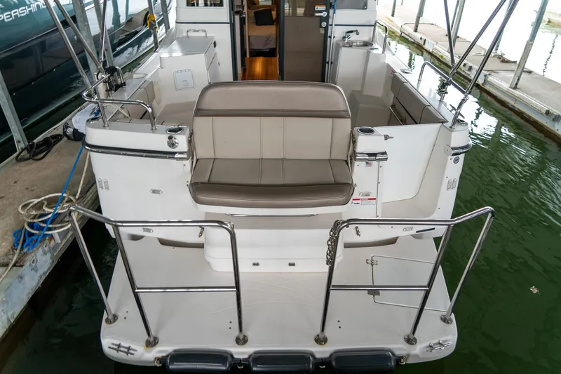 Slide: The Image of 2020 Cutwater C28 boat with rear seating, docked in a marina. - 9
