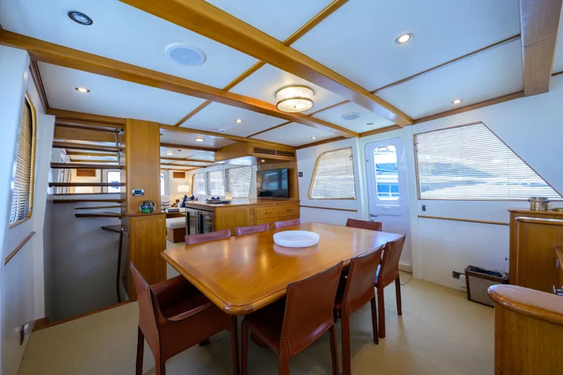Slide: The Image of Luxurious 2003 New England Boatworks Enclosed Raised Pilothouse interior with dining area and modern design. - 15