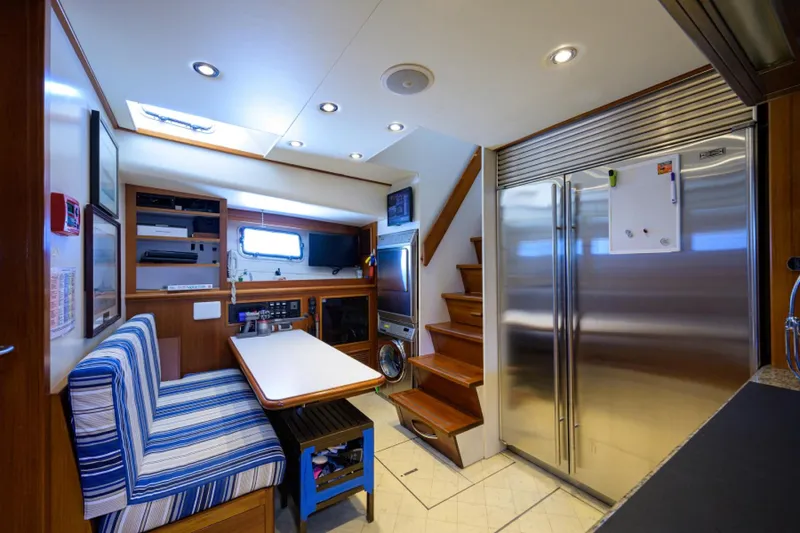 Slide: The Image of Luxurious 2003 New England Boatworks interior with modern kitchen and dining area. - 18