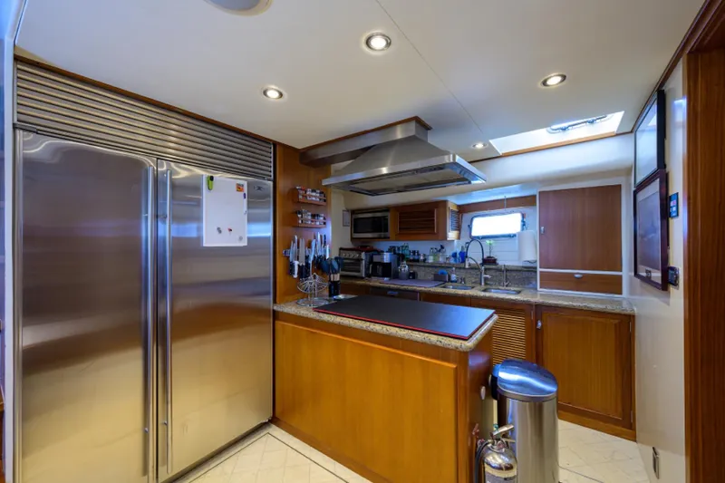 Slide: The Image of Luxurious yacht kitchen with stainless steel appliances, wooden cabinetry, and modern lighting. - 19