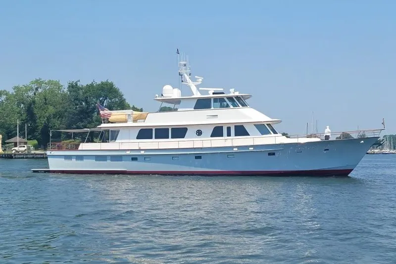 Slide: The Image of 2003 New England Boatworks Enclosed Raised Pilothouse yacht on calm water, side view. - 2