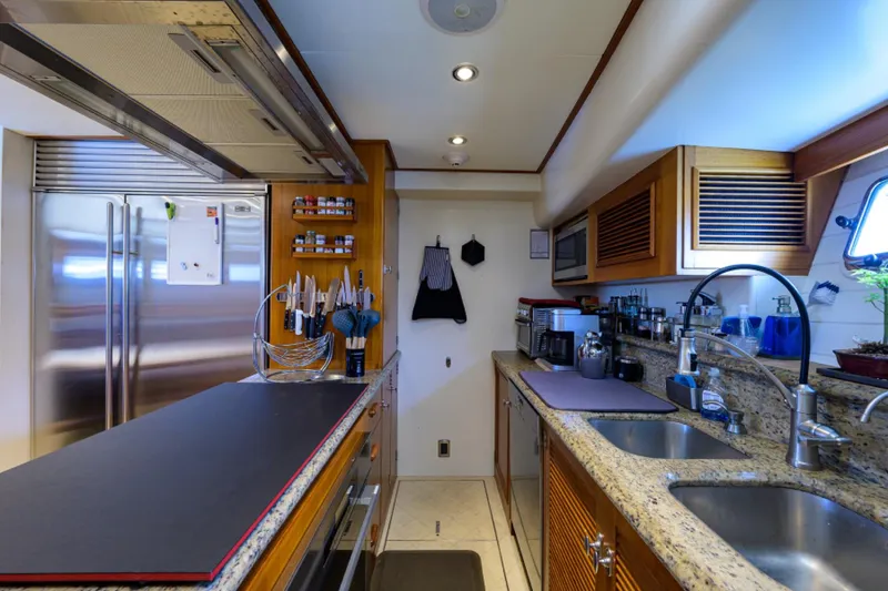 Slide: The Image of Luxurious yacht kitchen with granite countertops, stainless steel appliances, and ample storage. - 20