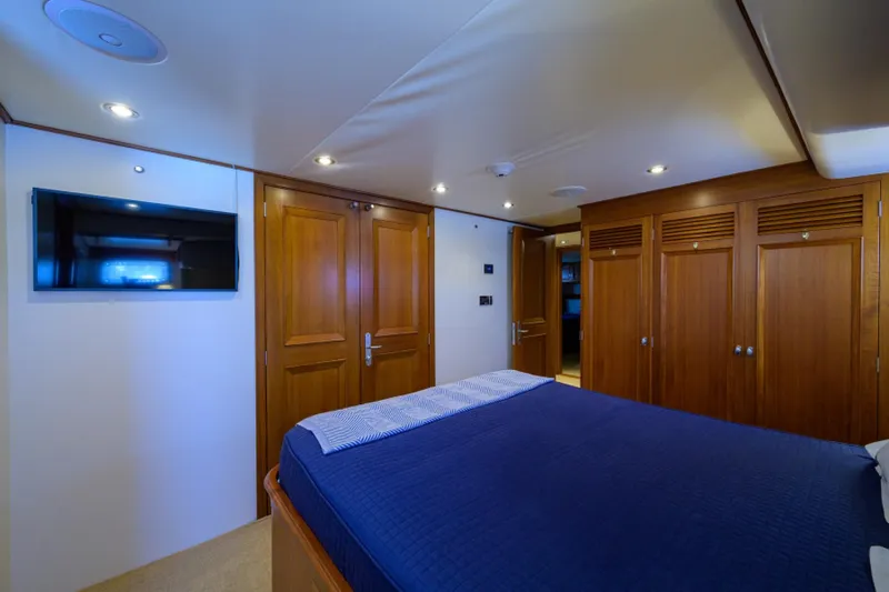 Slide: The Image of Luxurious cabin interior of 2003 New England Boatworks yacht with wood paneling and TV. - 22