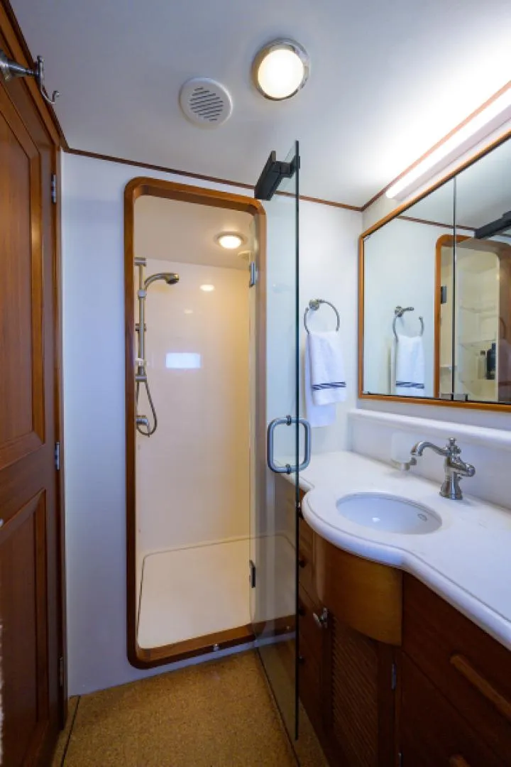 Slide: The Image of Luxurious 2003 New England Boatworks bathroom with shower, vanity, and wood accents. - 29