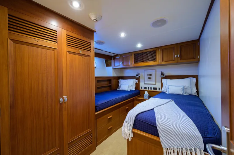 Slide: The Image of Luxurious twin cabin with wooden furnishings on 2003 New England Boatworks yacht. - 30