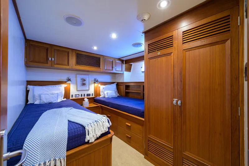 Slide: The Image of Luxurious cabin interior of 2003 New England Boatworks yacht with twin beds and wooden cabinetry. - 33