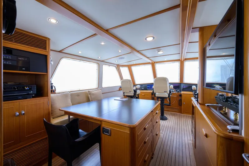 Slide: The Image of Luxurious 2003 New England Boatworks Enclosed Raised Pilothouse interior with wood finish and seating. - 35