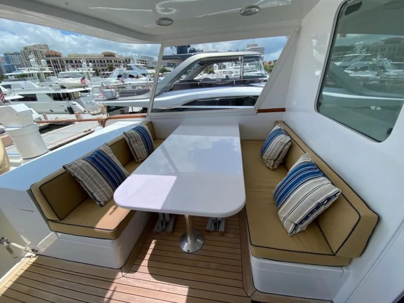 Slide: The Image of Luxurious 2003 New England Boatworks yacht with enclosed raised pilothouse, featuring elegant seating area. - 41
