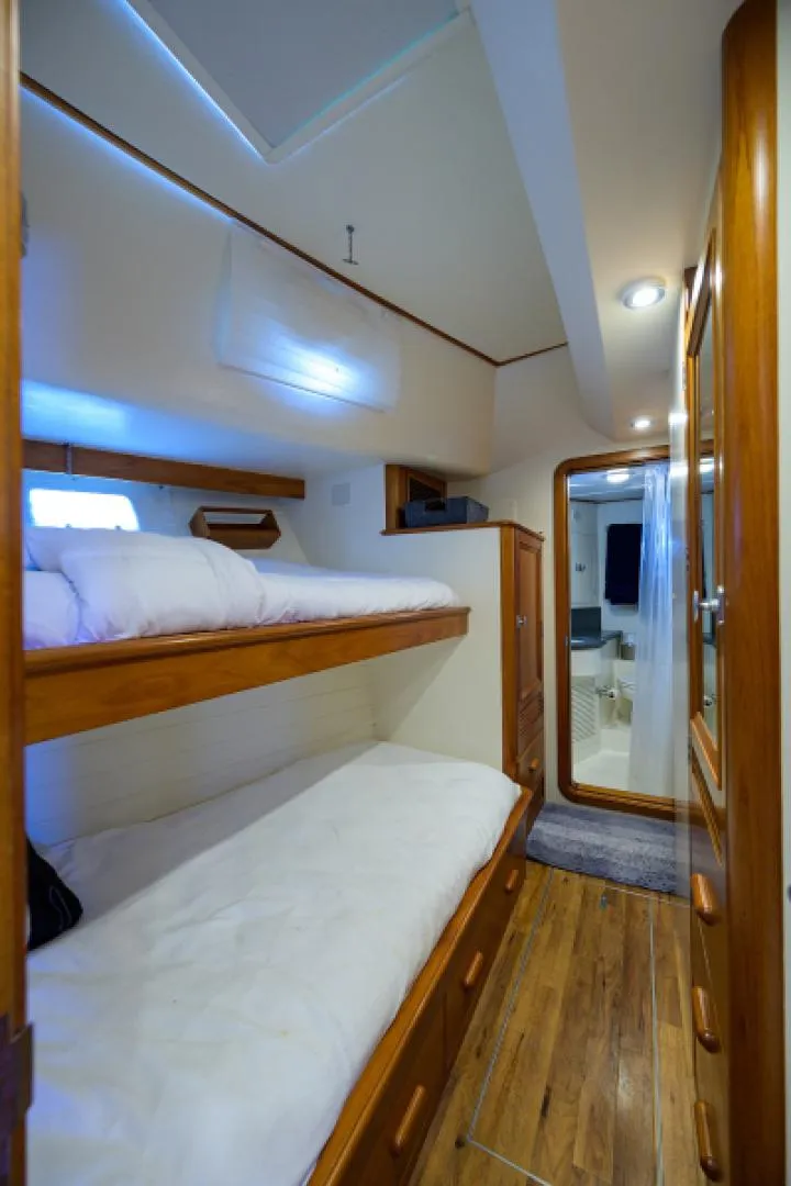 Slide: The Image of 2003 New England Boatworks Enclosed Raised Pilothouse interior with wooden bunk beds and modern design. - 43
