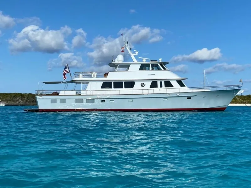 Slide: The Image of 2003 New England Boatworks yacht, Enclosed Raised Pilothouse, cruising on clear blue waters. - 47