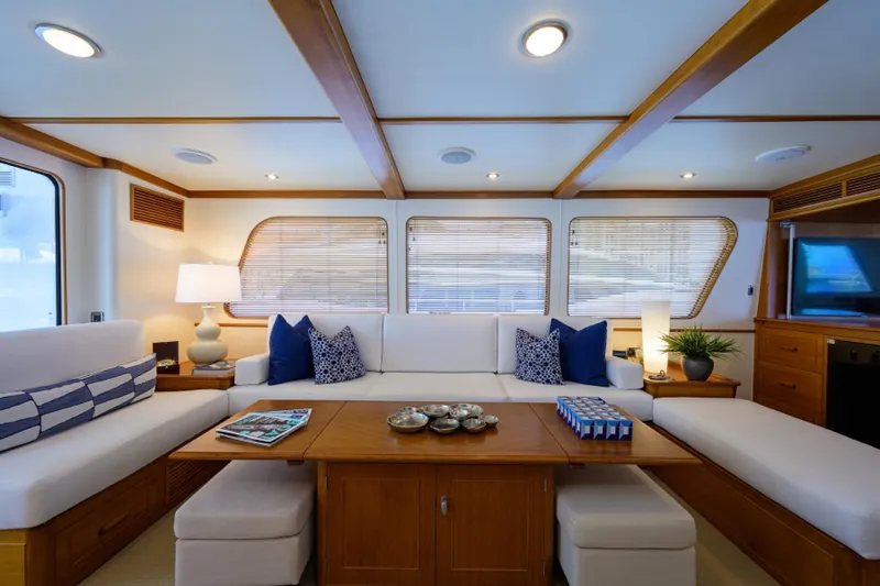 Slide: The Image of Luxurious 2003 New England Boatworks yacht interior with elegant seating and wooden accents. - 8