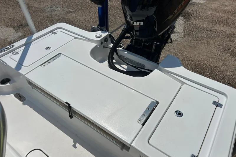 Slide: The Image of 2019 Sportsman Tournament 214 Bay Boat deck with storage compartments and outboard motor. - 10