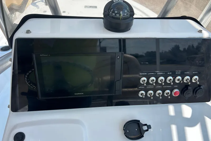Slide: The Image of 2019 Sportsman Tournament 214 Bay Boat dashboard with Garmin GPS and control switches. - 5