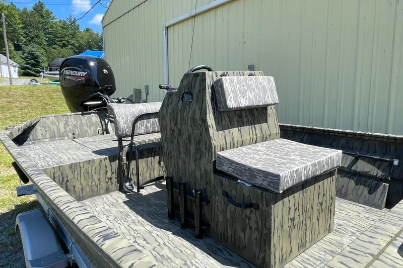 Slide: The Image of 2026 Lund 1870 Predator CC boat with camouflage design and Mercury outboard motor. - 10