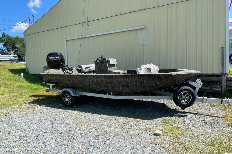 Slide: The Image of 2026 Lund 1870 Predator CC boat on trailer, parked outdoors. - 9