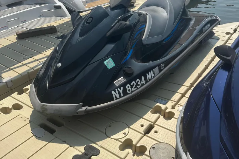 Slide: The Image of 2014 Yamaha WaveRunner VX Cruiser on dock, black with blue accents, registration NY 8234 MK. - 1