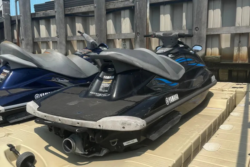 Slide: The Image of 2014 Yamaha WaveRunner VX Cruiser jet ski on dock, black and blue design. - 6