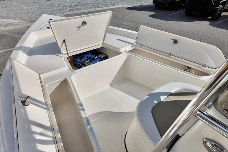 Slide: The Image of 2026 Bulls Bay 2200 boat interior with open storage compartments and seating. - 10