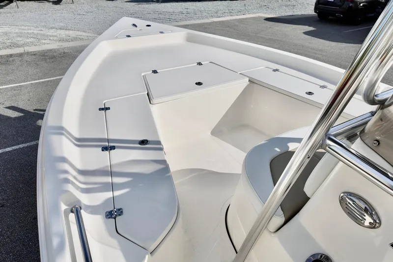 Slide: The Image of 2026 Bulls Bay 2200 boat interior with sleek white deck and storage compartments. - 6
