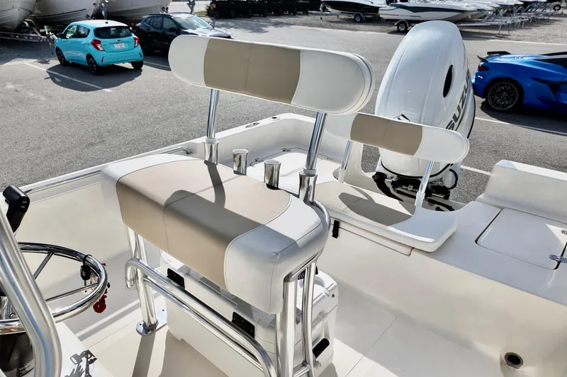 Slide: The Image of 2026 Bulls Bay 2200 boat interior with seating and steering wheel, parked in a lot. - 9