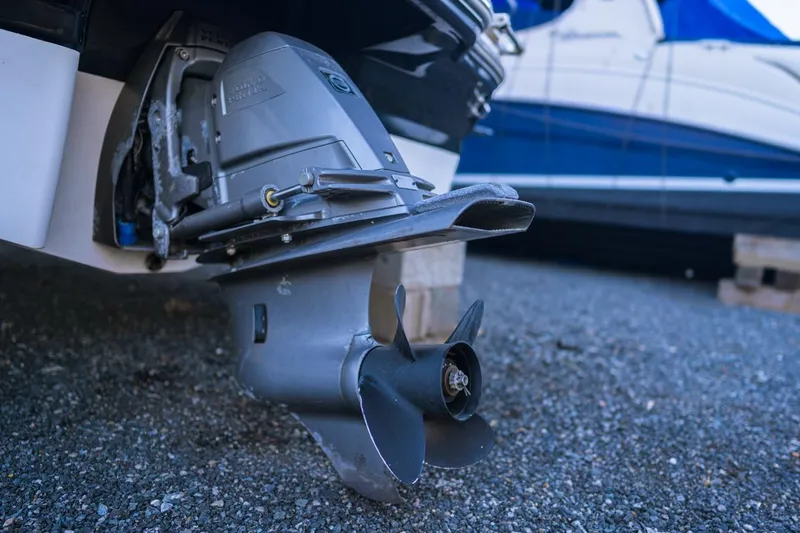 Slide: The Image of Outboard motor of 2018 Chaparral 210 Suncoast boat on gravel surface. - 10