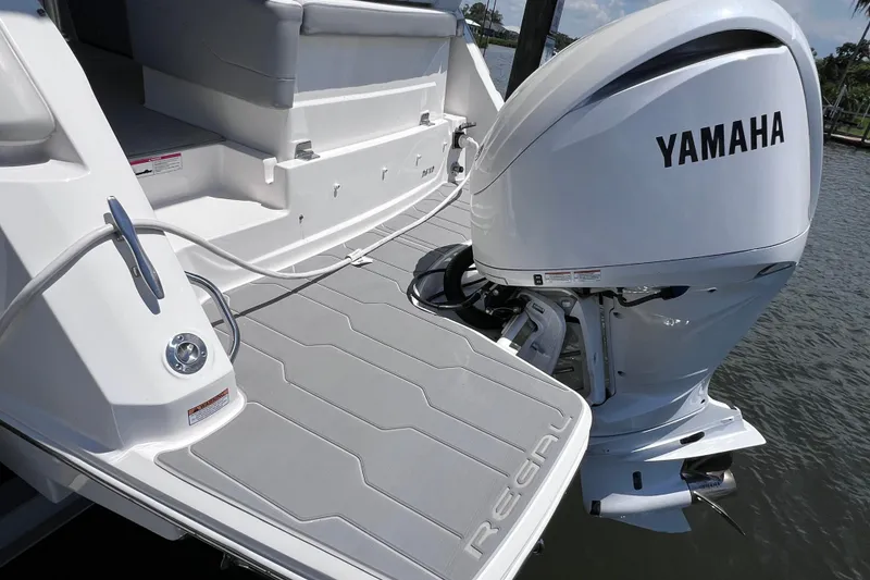 Slide: The Image of 2024 Regal 26 XO boat with Yamaha outboard engine on water. - 11