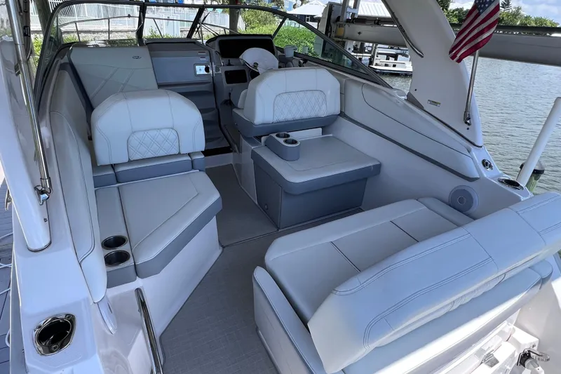 Slide: The Image of 2024 Regal 26 XO boat interior with luxurious seating and American flag. - 12