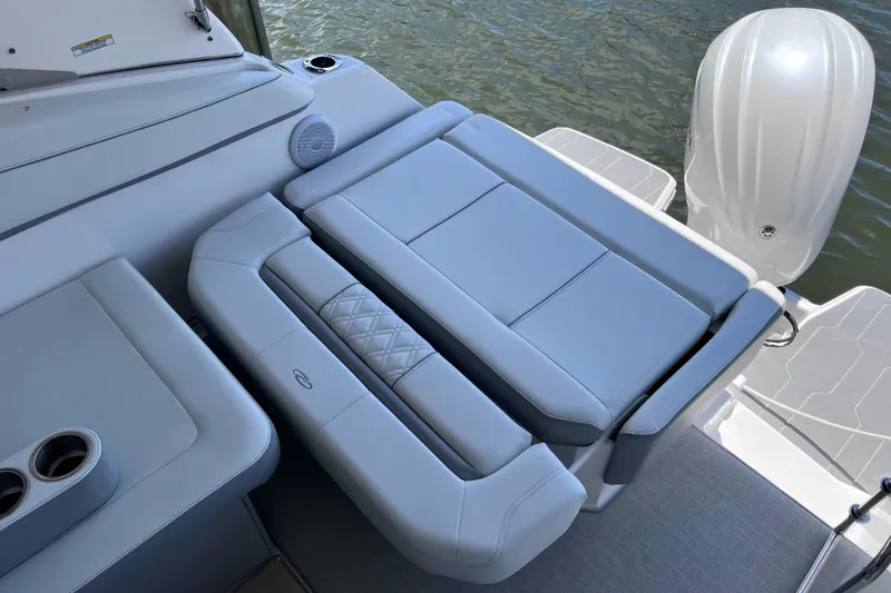 Slide: The Image of 2024 Regal 26 XO boat with luxurious seating and outboard motor on water. - 16